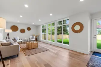 Spacious light filled rec room leads to the large back yard