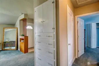 Convenient built-in storage and closet located just around the corner in the hallway.