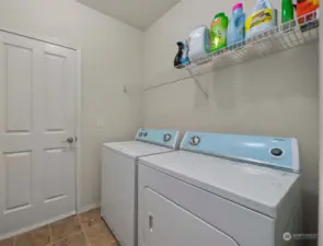 The utility room, with easy access to the garage, houses the washer and dryer (included), making laundry tasks a breeze and offering seamless integration between household chores and storage needs.