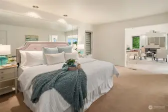 Unwind in your expansive primary suite, featuring dual walk-in closets with convenient built-ins, a private entrance to the deck, a luxurious en-suite bath, and an additional dedicated space for relaxation.