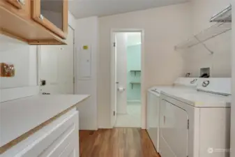 Laundry room boasts cabinets and counter space