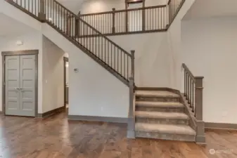 Thoughtfully designed open railing staircase leads to an overlook of the expansive great-room!