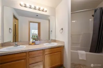 The full, ensuite bathroom is located just off the primary bedroom. With two sinks and an oversized vanity, there is room for all of your things. Everything about this unit lives large, including the bathroom!