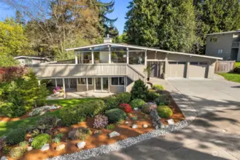 Stunning Mid-Century Modern with beautiful landscaping and curb appeal.