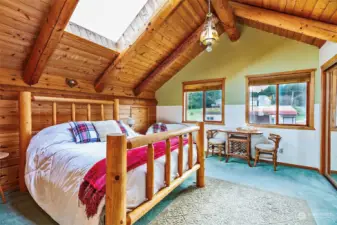 Loft primary en suite is light and bright with vaulted ceilings & skylights.