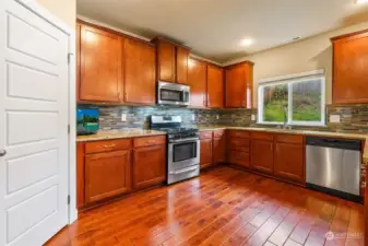 Generous kitchen, granite counters and gas cooking.