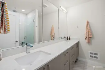Dual sinks and quartz countertops are another highlight of the primary bath.