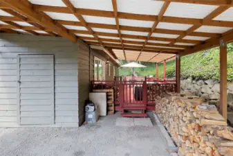 Covered carport with storage shed. Fire wood sold separately.