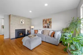 Spacious living room with newer wood burning fireplace insert.