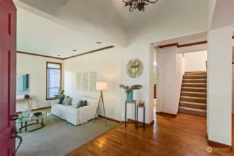 Greeted by hardwood floors, to the left you see the large living room.
