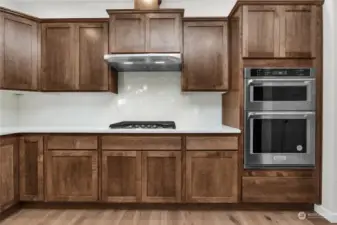 Elegant kitchen with gas cooktop and built-in oven and microwave