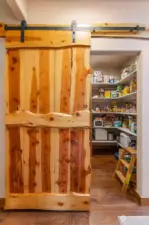 Hand made barn door; looking in to huge walk-in pantry.
