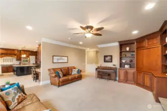 Spacious family room with ceiling fan and built-ins.