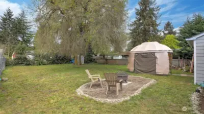 Large back yard with space for fire pit, gazebo, storage shed, garden space, flower beds, and all the outdoor activities you can think of!