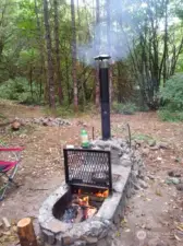 Campground area includes grated fire grill with chimney