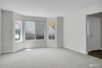 Cozy living room with bay window, lots of natural light. Fresh paint & New carpet throughout!