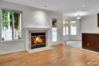 Family Room off kitchen with fireplace, lots of windows brings nature in.