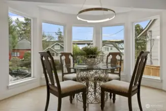 Dramatic dining room framed by bay window.