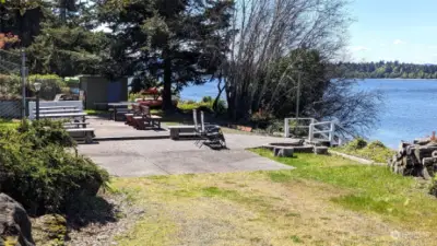 Private beach picnic area with tables, sink, porta-potty, fire pit, kayak storage, and stairs to dock and BEACH!