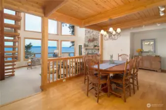 Formal dining area boasts built ins, tongue and groove beamed ceilings and wide water views. Full height fireplace warms you. Gatherings will be fabulous here!
