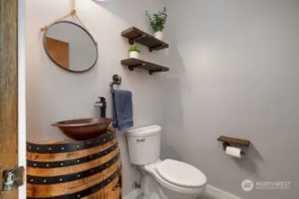 Cute half bath with wine barrel cabinetry and cute sink.