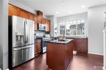 Kitchen offers upgraded appliances, granite counters, full backsplash, gas cooking and is wired for pendant lighting above the kitchen island!