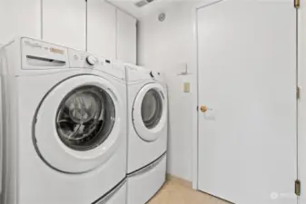 Laundry room with built-in cabinetry.