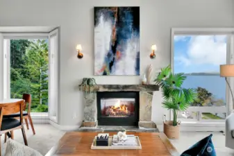 Stone surrounded gas fireplace flanked by views. This home offers wonderful spaces for art.
