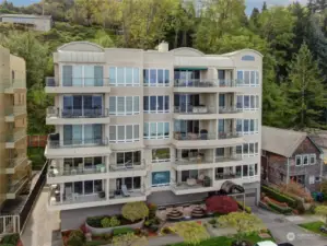 Elegant 16 unit building at 1210 Alki Ave SW features beautifully maintained landscape and lovely water feature.