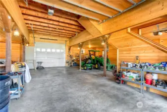 Timber lined barn/storage building includes loft storage and a drive thru door to the rear of the property.