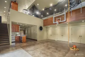 Glass garage door that opens to a large patio, regulation free throw box in floor, adjustable Basketball  Hoop, climbing rope, TV, kitchenette/Wet bar with microwave, SubZero beverage refrigerator, sink, disposal, custom cabinets.