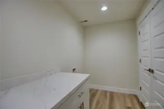 Large Laundry room with loads of storage space.