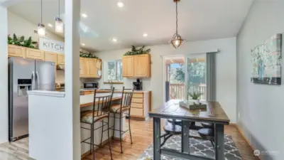 Incredible kitchen boasts Stainless Steel appliances with a newer stove & microwave, an island with eat-in seating on both sides, a skylight and vaulted ceilings. All appliances stay.