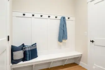 Mud room off 3 car garage leads to the  kitchen. Built-in bench seating, coat hooks  and a coat closet round out this useful space.