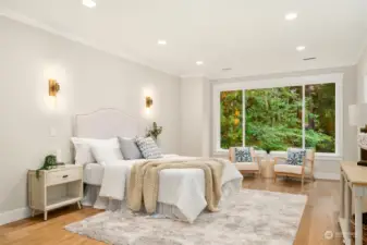 The primary bedroom will definitely wow  you! French doors to lead you in, huge  picture window to take in the view, sconces  on either side of the bed, beautiful hardwood  floors and high ceilings.