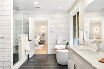 Primary bathroom is the epitome of luxury!  Floor to ceiling tiles, slipper soaking tub,  massive walk-in shower, double sinks, water  closet, heated ceramic tile floors, and huge  walk-in closet.