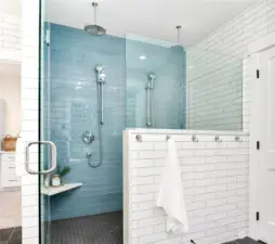 This oversized walk in shower is a must see  with glass tile accent wall, 4 shower heads  and tons of space!