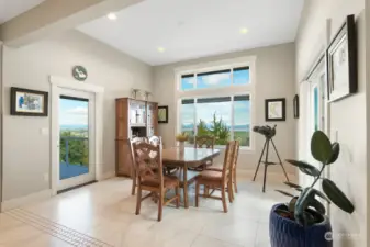 Opposite doors frame the dining space! Slider to right goes out on the largest of Main Level Decks. Door on left includes internal blinds accessing Primary Bedroom #1 Private Deck. An exceptional view to be enjoyed dining or playing games in this wonderful space off the Kitchen!