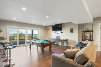 Welcome to the MAGNIFICENT Game Room includes a custom built-in seating bar and kitchenette. Sliding doors open out to XL Cement Patio on Lower Level. Perfect for entertaining and having fun (all with a stellar view and fresh air!).
