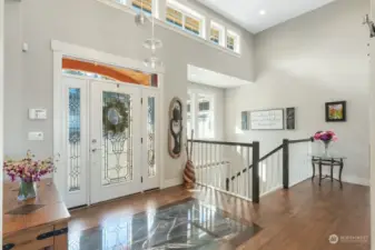 As it should be, this entry is exquisite, spacious, light and inviting. The entryway is inlaid with a solid granite slab framed in a dark wood border.