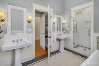 Primary bath has soaking tub, shower and double pedestal sinks.