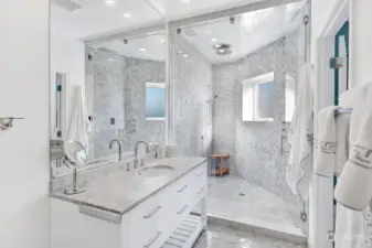 Downstairs primary bath with glass-enclosed steam shower