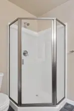 The corner shower in the primary bath.