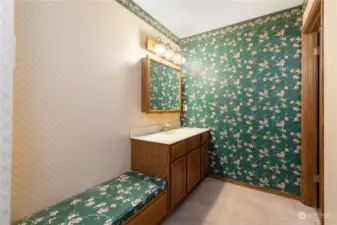 Primary bathroom with built-in bench and ample storage.