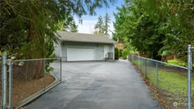 Gated entry with long driveway that goes all the way to the back of the house on the side for more parking options.