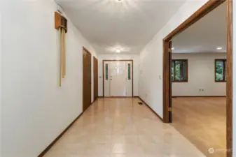 Front door entry and wide tiled hallway, french doors to the right lead to a giant family/great room.