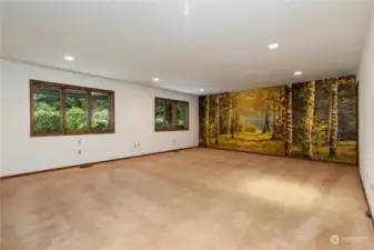 Giant family/great room is warm and inviting with a fabulous mural.  Nice Andersen windows throughout the home.