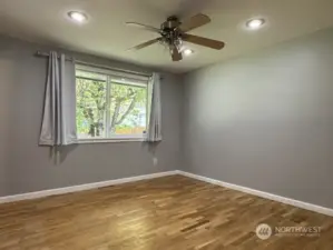 Primary bedroom with beautiful hardwood flooring, closet organizer and private bath.
