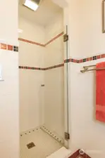 Main floor shower with ceramic tile surround.