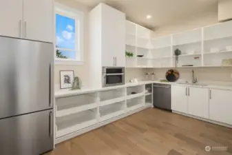 Prep kitchen with a fridge and freezer, microwave, second dishwasher, sink & ample storage space!